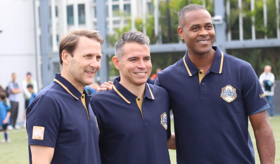 Eight Real Madrid and Barcelona Greats Join Youngsters for Rondo and Match During School Visit; Kluivert Smiles as He Signs Rival Jersey
